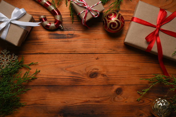 istock Gifts, fir tree branches, red decorations on wooden background. Flat lay, top view, copy space. 1344371138