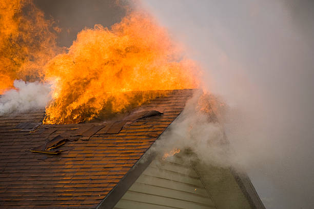 Burning wooden house at night.