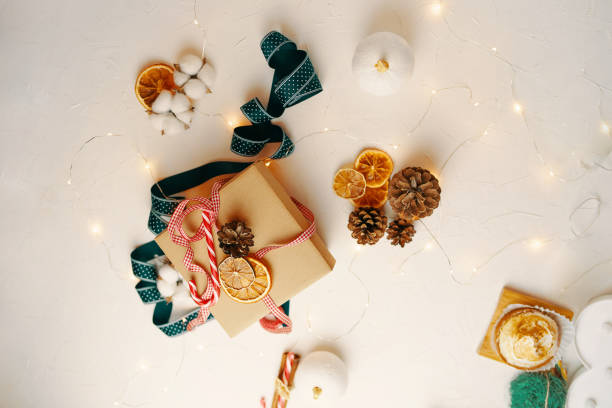 istock Christmas gift box and decorations on white table. 1344375339