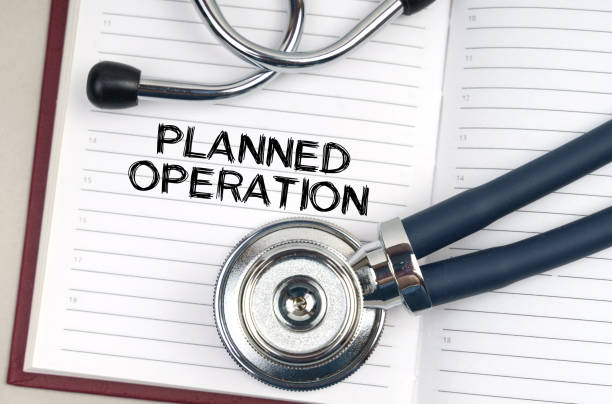istock On the table is a stethoscope, a pen and a notebook in which it is written - Planned operation 1344376293