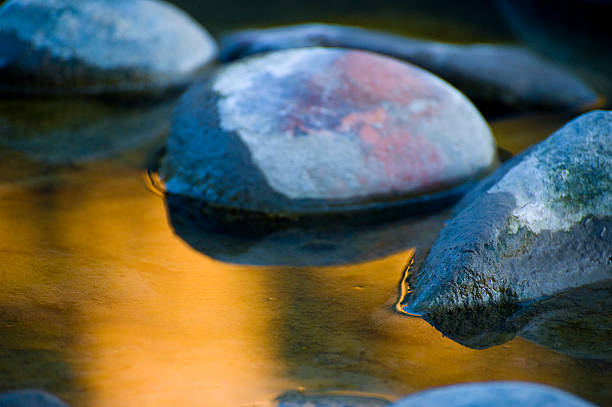 istock Cool Rocks and Warm Reflection in Water by the River 134437690
