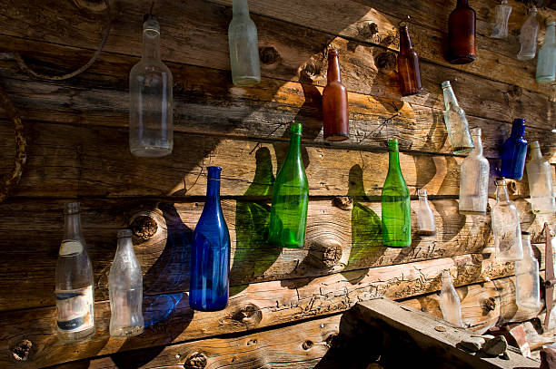 istock Bottles Made of Glass on Log Cabin 134438016