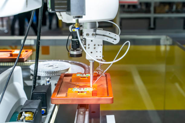 istock automatic robot for print circuit board (PCB)assembly machine during soldering or welding part 1344380404