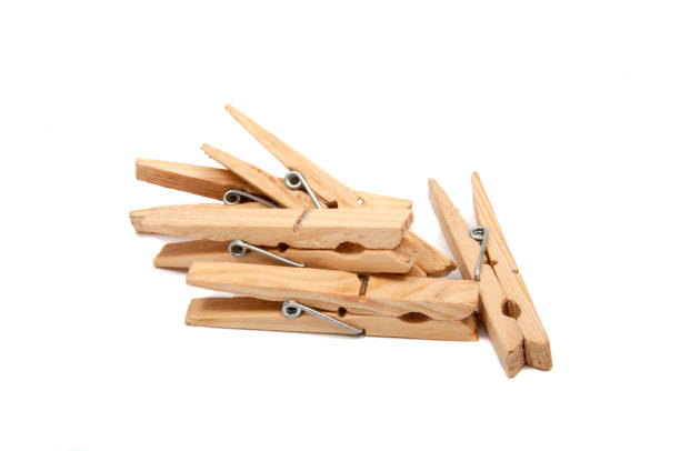istock wooden clothes pegs isolated on the white 1344382759
