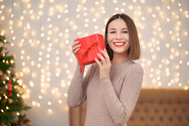 istock Portrait young beautiful woman hold a gift box 1344385571