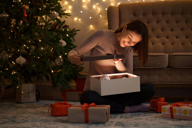 istock Happy beautiful woman opening a gift 1344385811