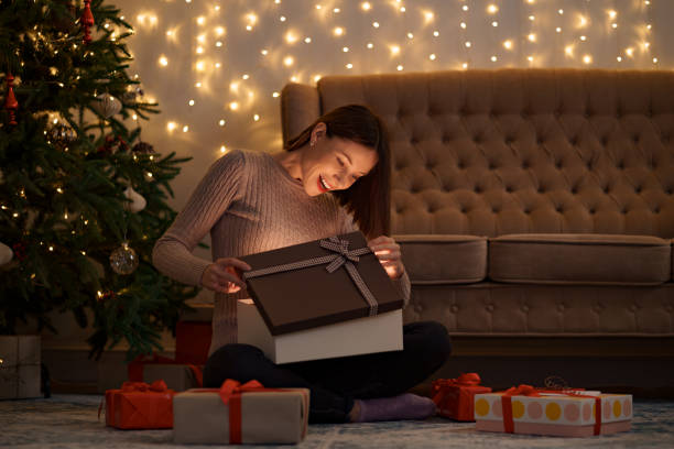istock Happy beautiful woman opening a gift 1344385815