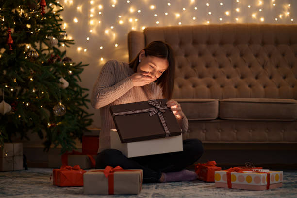 istock Happy beautiful woman opening a gift 1344385817