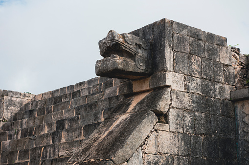 The most famous pyramid of Yucatan and an iconic symbol of Mexico. The temple Kukulcán originates from the times of the Maya and Aztec civilisation. Here a snake decoration at one of the pyramid walls.