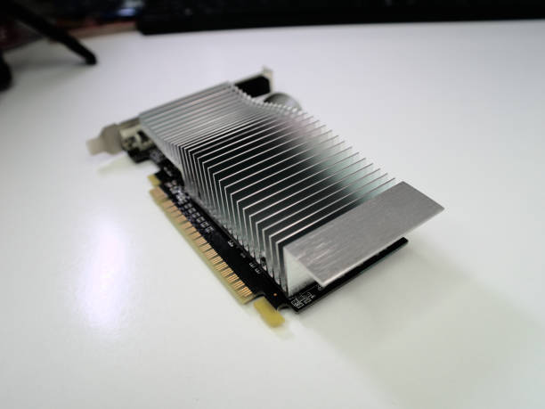istock Computer graphics card with the aluminum passive cooler, standing on a white desk, close up 1344388051