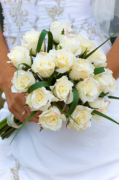 istock Beautiful Young Bride in Window Light with Flower Bouquet 134438966