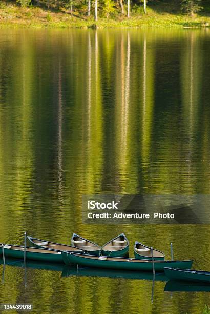 Reflection Of Canoes On A Pristine Calm Lake At Sunset Stock Photo - Download Image Now