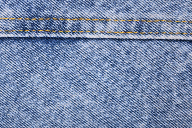 istock Old blue jeans background and texture close up.Denim seam. 1344395898