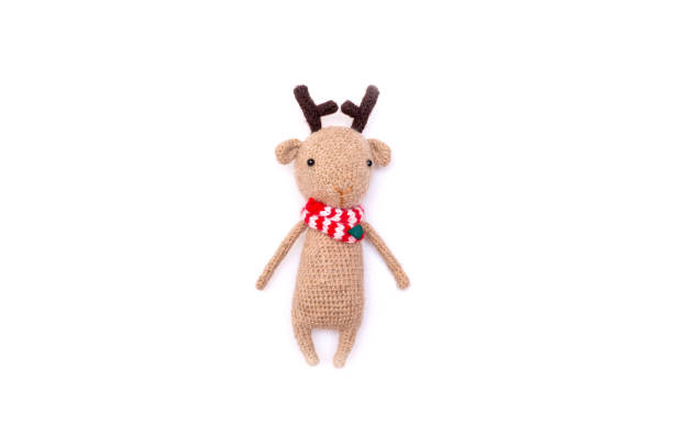 istock reindeer knitted with a red scarf isolate on a white background. 1344395937
