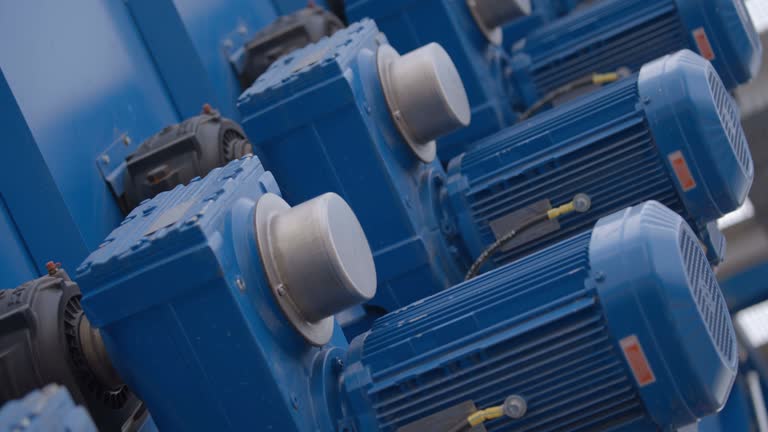 Rows of blue powerful industrial motors in the processing line of a new factory