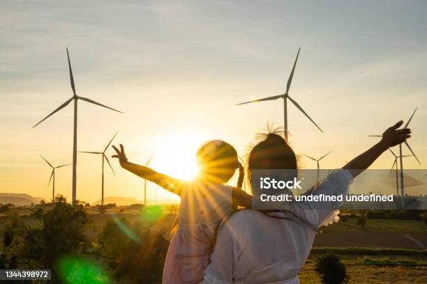 Wind Turbines Are Alternative Electricity Sources The Concept Of Sustainable Resources People In The Community With Wind Generators Turbines Renewable Energy Stock Photo - Download Image Now