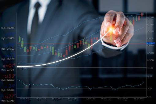 Businessman with a graph showing the ups and downs of stock. Concept of doing an online business called stock trading. Business education quickly with the use of 5G and 6G technology in the future.