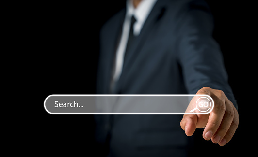 Businessman hand pressing blank search bar on a virtual online computer or screen to Searching for information. Data Search Technology Search Engine Optimization. Search Console for your website.