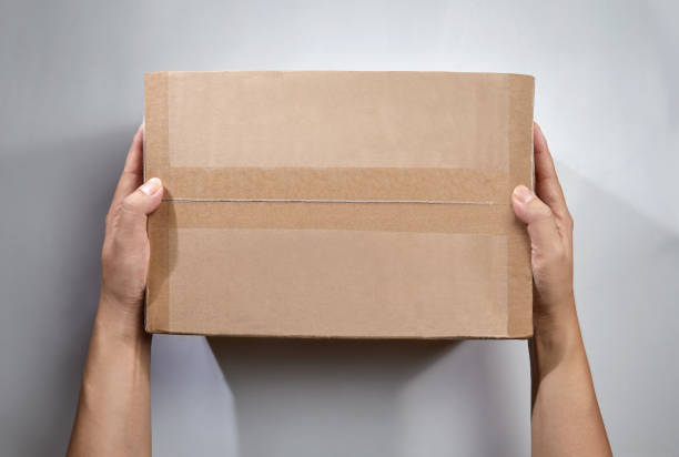 istock Top view of hand holds the package or parcel box 1344402829
