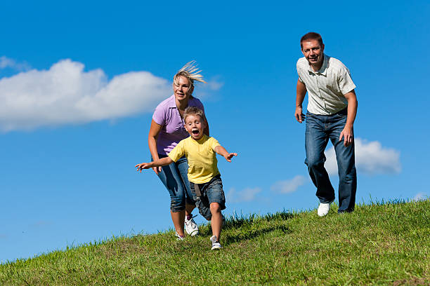 istock Family outdoors is running on a meadow 134440576
