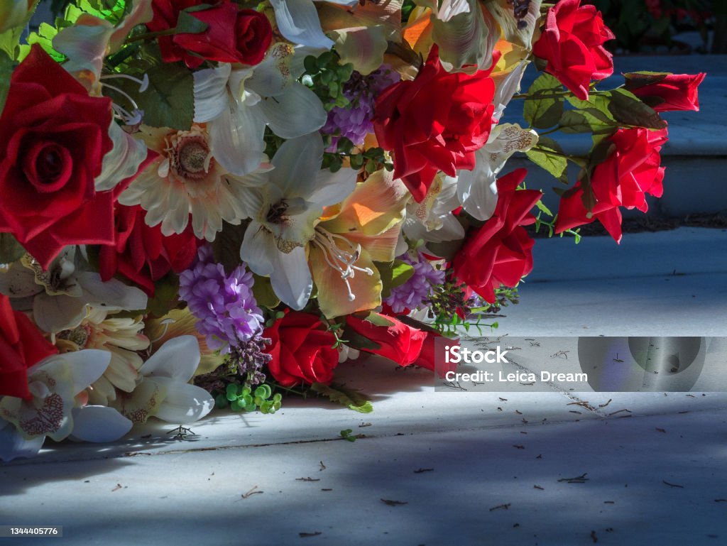 Flowers on a tomb. Cemetery. Graveyard. all saint's day. Day of the dead. November Bouquet Stock Photo