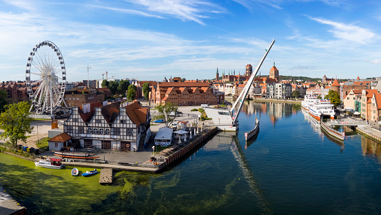 The classic view of Gdansk Old Town with the Hanseatic-style buildings, ferris wheel  and bascule bridge over Motlawa river, Poland