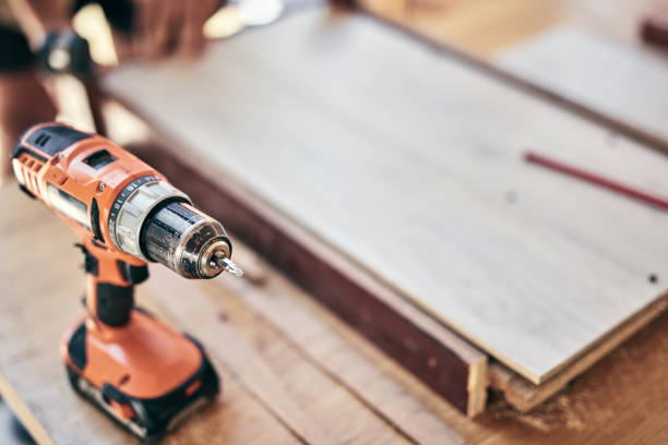 istock Handyman's power cordless drill for fixing furniture and various things. 1344409246