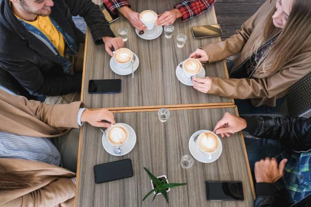 istock Young friends drinking cappuccino inside vintage bar - Main focus on bottom hands holding cups 1344410101