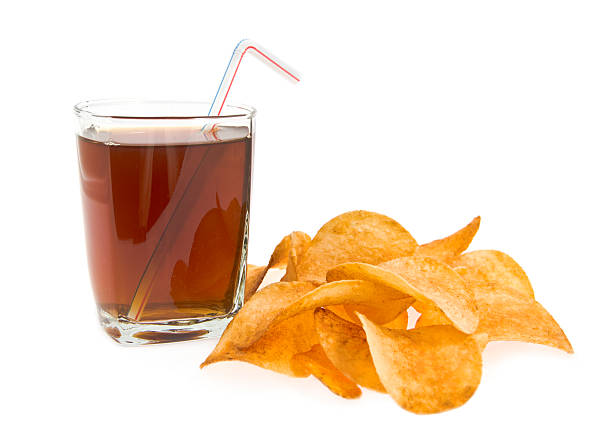 glass  drink and tube with lying alongside chips