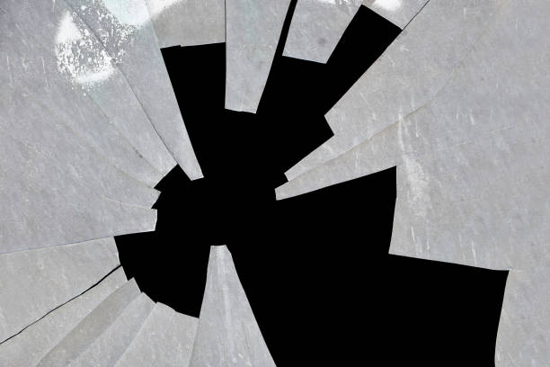 broken glass texture in shattered window on black background.