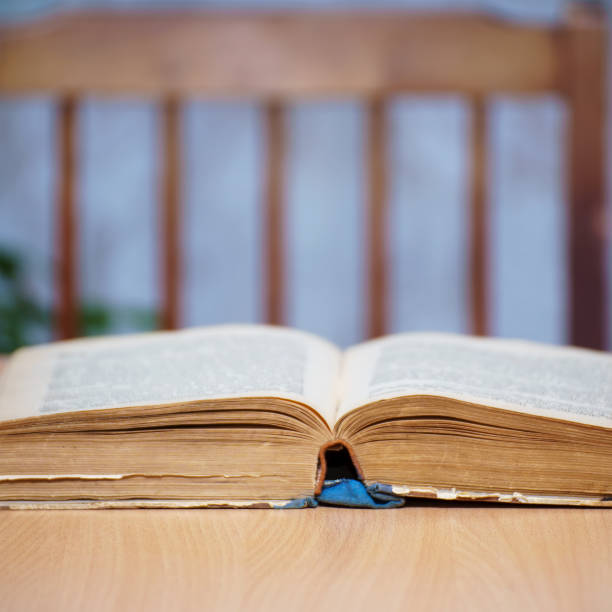 istock Open book on a wooden table 1344411895
