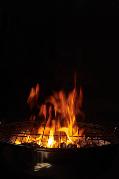 istock Grill Background. Barbecue Fire Grill close-up, isolated on Black Background 1344412007