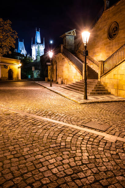 historical staircase at charles bridge by night - prague mirrored pattern bridge architecture imagens e fotografias de stock