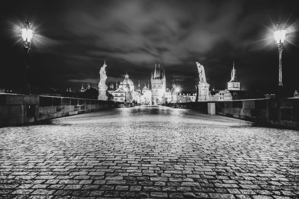 Night on Charles Bridge, Czech: Karluv most, with Old Town Bridge Tower, Prague, Czech Republic. Black and white image.