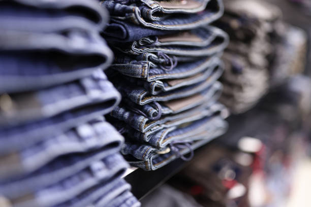 Stack of blue jeans in different shades at store. Casual wear concept