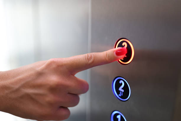Woman finger presses a button in elevator closeup Woman finger presses a button in elevator. Elevator service concept hand elevator stock pictures, royalty-free photos & images
