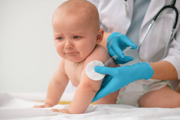 istock Cute tranquil Caucasian newborn patient getting vaccinated 1344412748