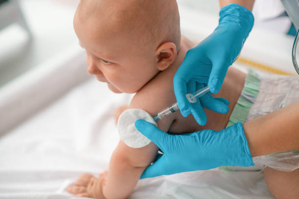 istock Calm cute newborn child getting an injection 1344412761