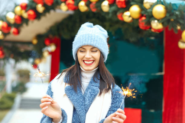 istock Cool lady enjoying holidays with sparklers 1344412838