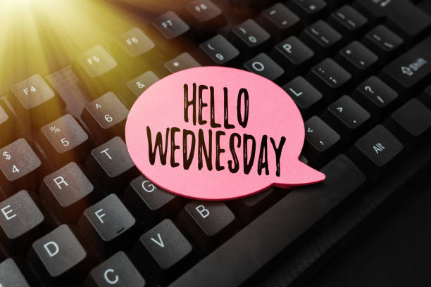 text caption presenting hello wednesday. word written on hump day middle of the working week of the calendar paper note on keyboard for notes on notebook in office work - caption imagens e fotografias de stock