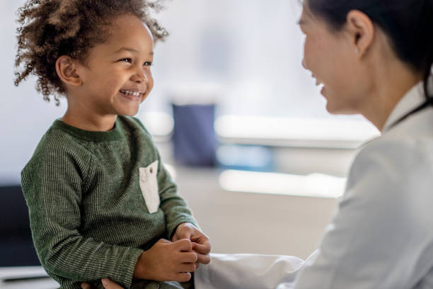 istock Doctor Tickling Young Boy 1344413173