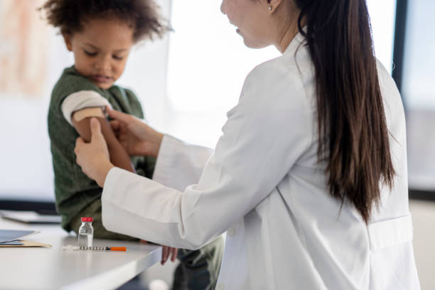 istock Doctor Putting a Bandage on a Little Boy 1344413180