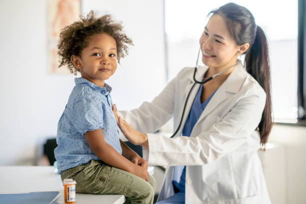 istock Doctor Giving a Little Boy a Physical Examination 1344413206