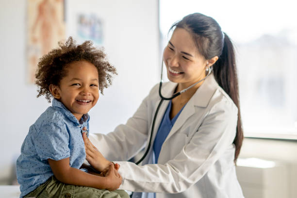 istock Little Boy Giggling at the Doctors 1344413208