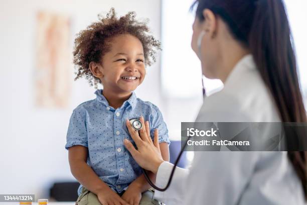 Doctor Listening To Little Boys Heart Stock Photo - Download Image Now - Doctor, Healthcare And Medicine, Child
