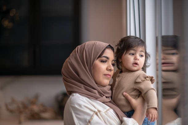 istock Looking Out the Window with Mommy 1344413332