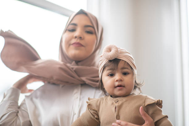 istock Muslim Mother with her Baby on Her Lap 1344413358