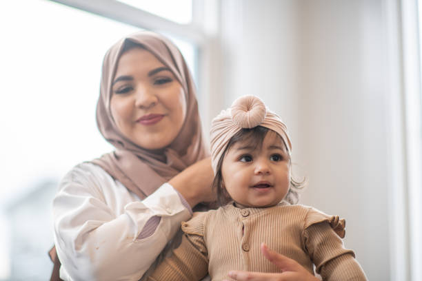 istock Muslim Mother with her Baby on Her Lap 1344413364
