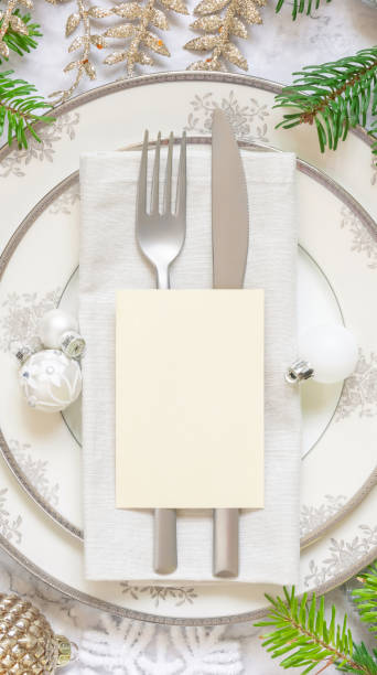 istock Festive table setting of with fir tree branches and Christmas decorations. Card mockup 1344413460
