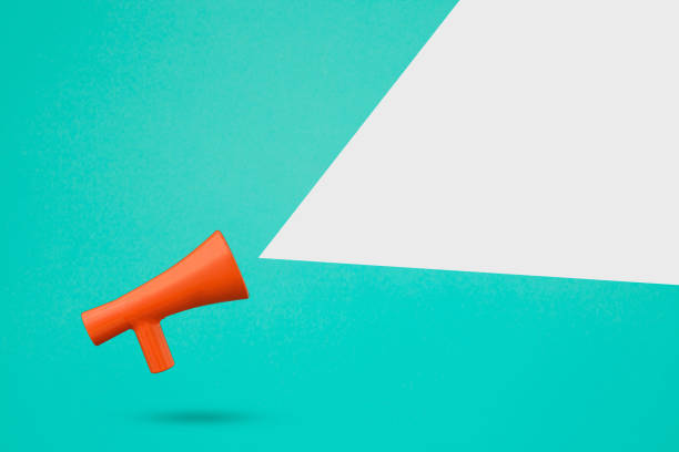 istock Blank grey copy space with red 3d megaphone icon against turquoise